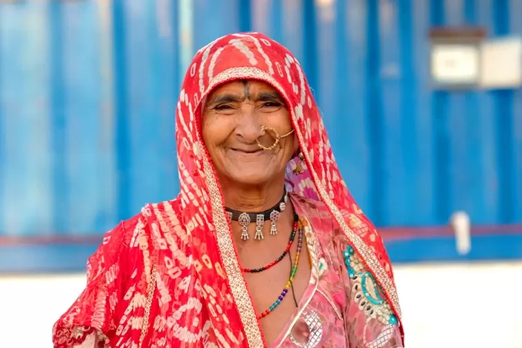 An Indian woman radiates energy in a red sari.