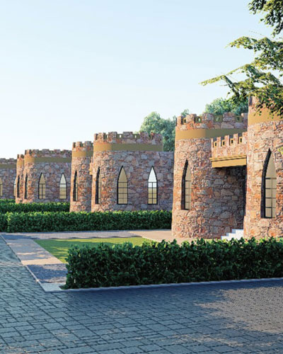 Real estate featuring stone castle walls with arched openings lined by a paved path and green hedges under a clear sky.