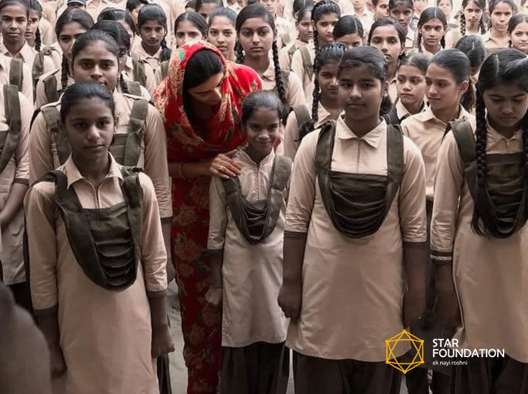 A woman from the Star Foundation is standing in front of a group of girls.